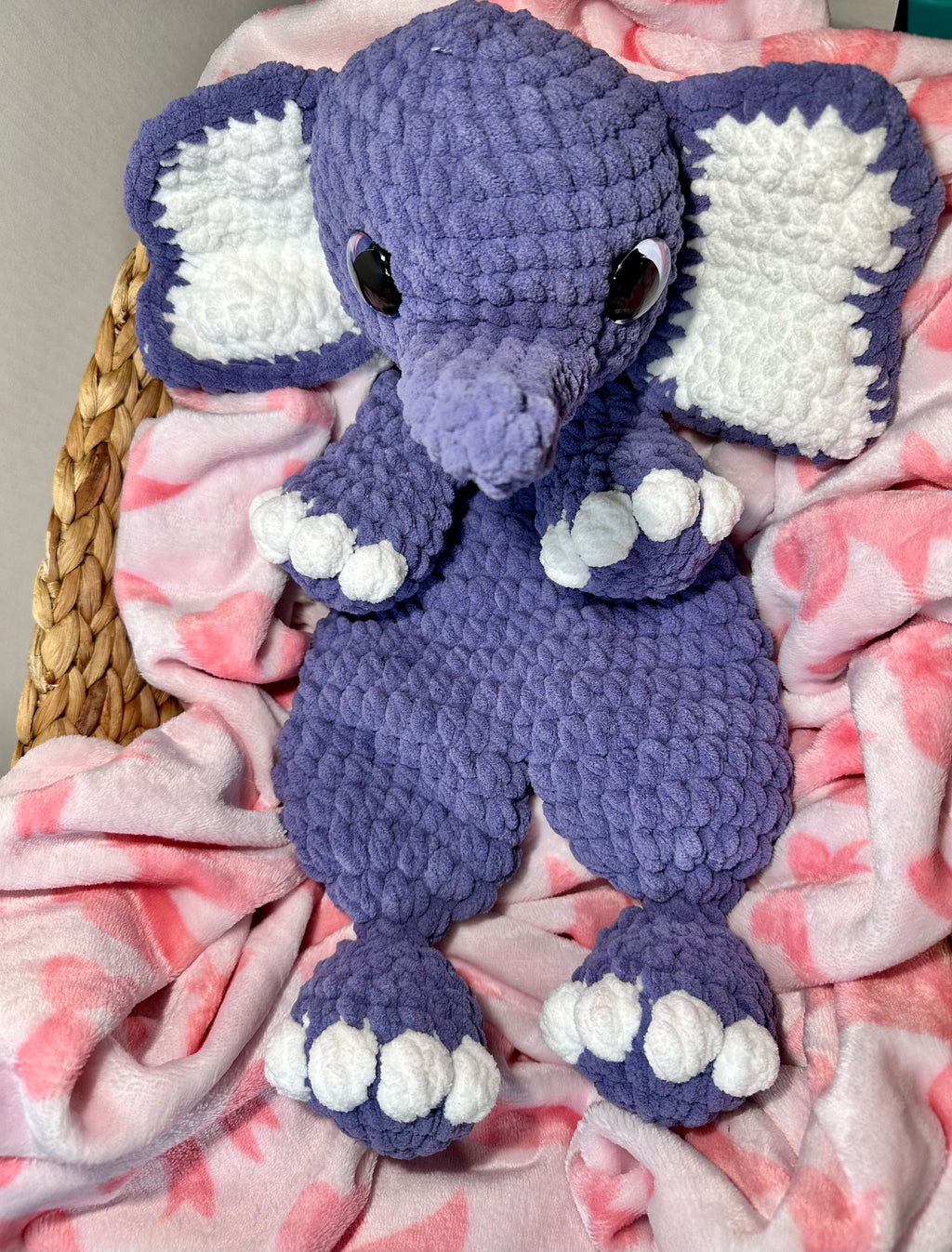 Handmade crochet periwinkle elephant snuggler with white inner ears and toe details