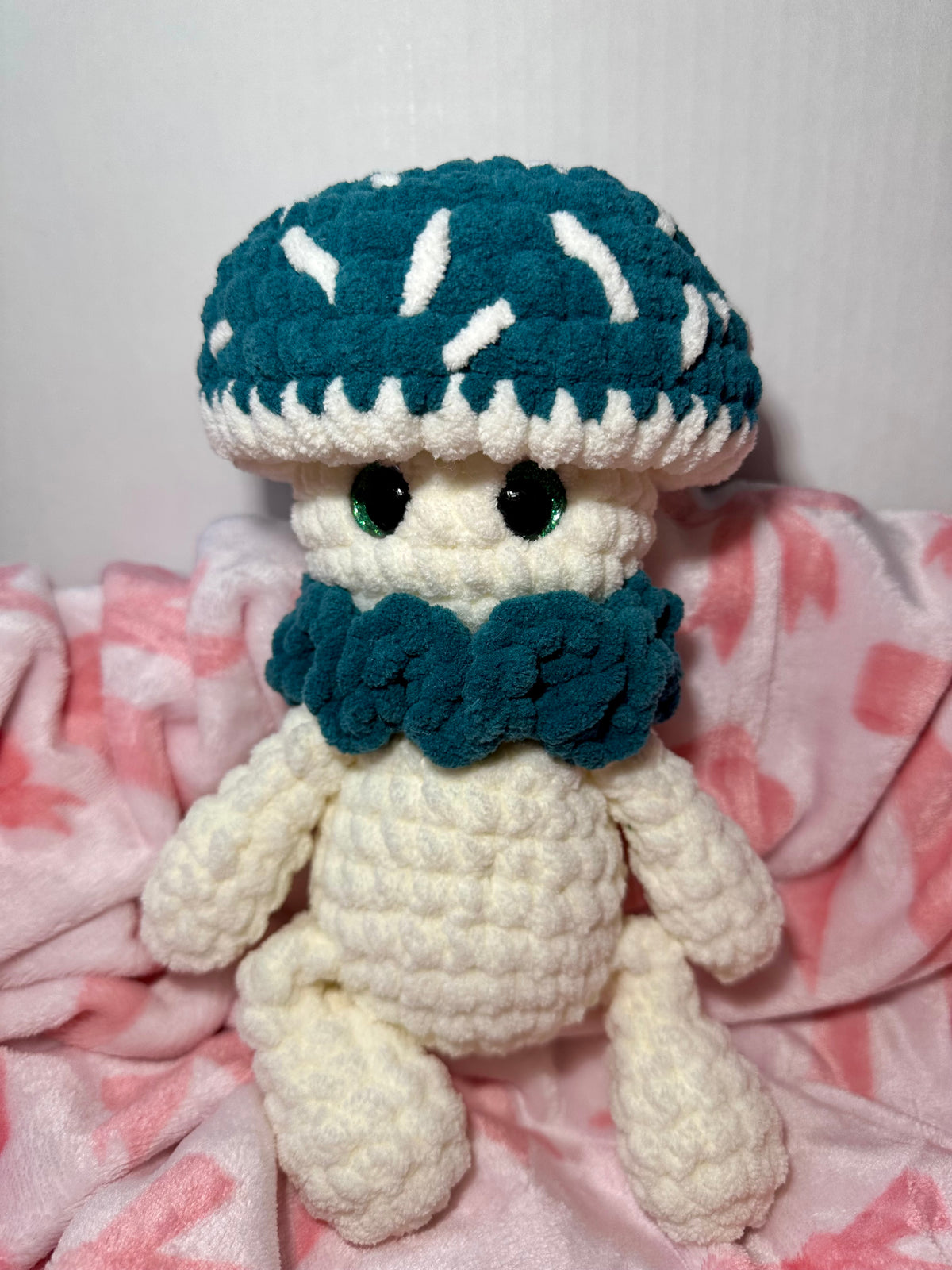 Mossy the Mushroom — front view showing teal ruffle collar and white speckle cap details