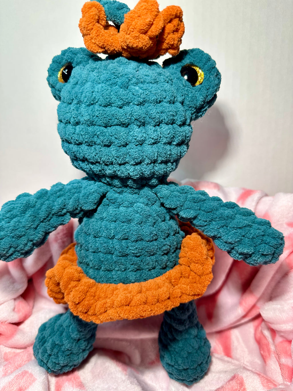 Fern the Frog Queen — handmade crochet frog plushie in teal with orange crown and caramel skirt