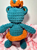 Fern the Frog Queen — handmade crochet frog plushie in teal with orange crown and caramel skirt
