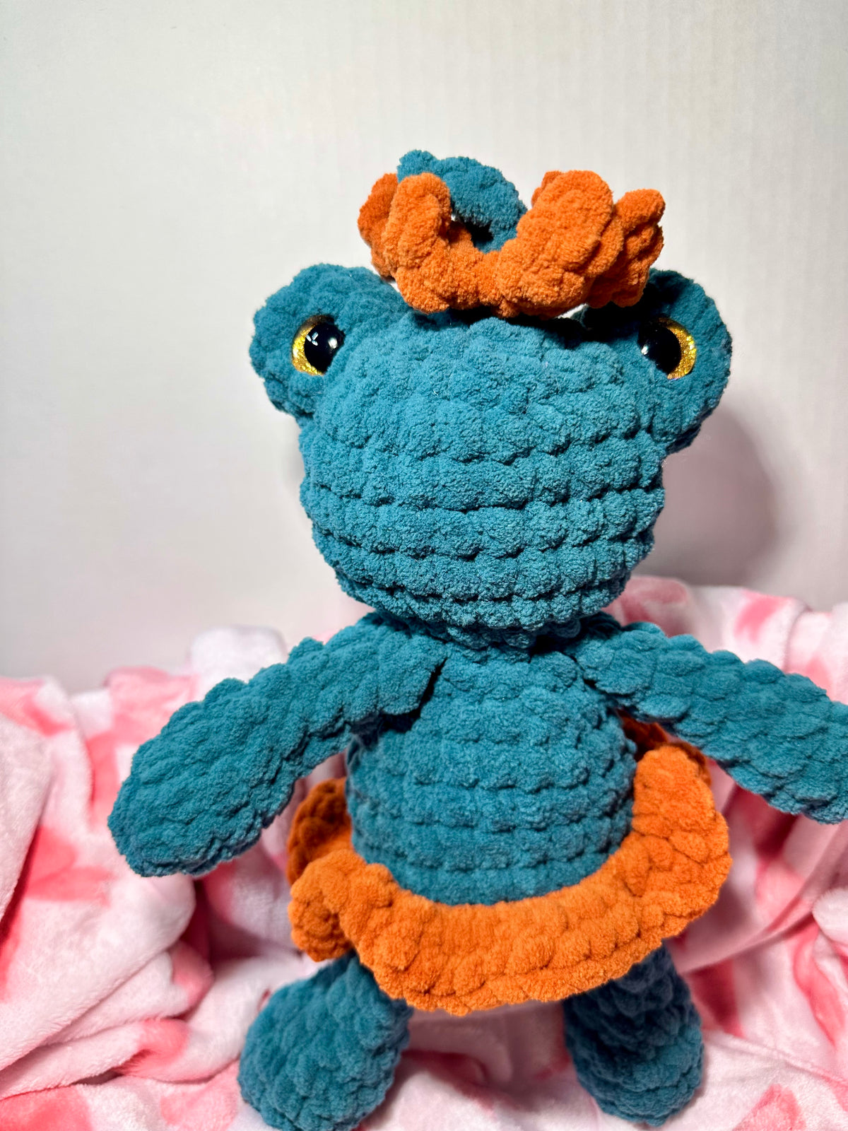 Fern the Frog Queen — close-up showing golden safety eyes and orange crown detail