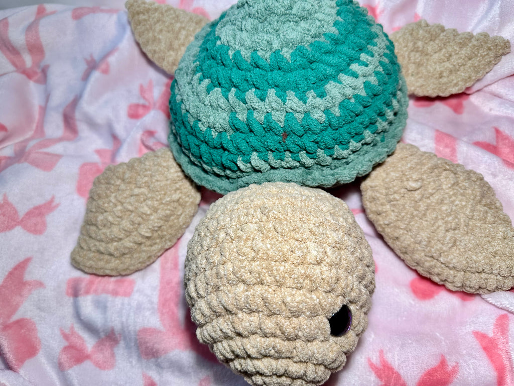 Greeny the Sea Turtle — top view showing spiral shell pattern and sandy beige flippers