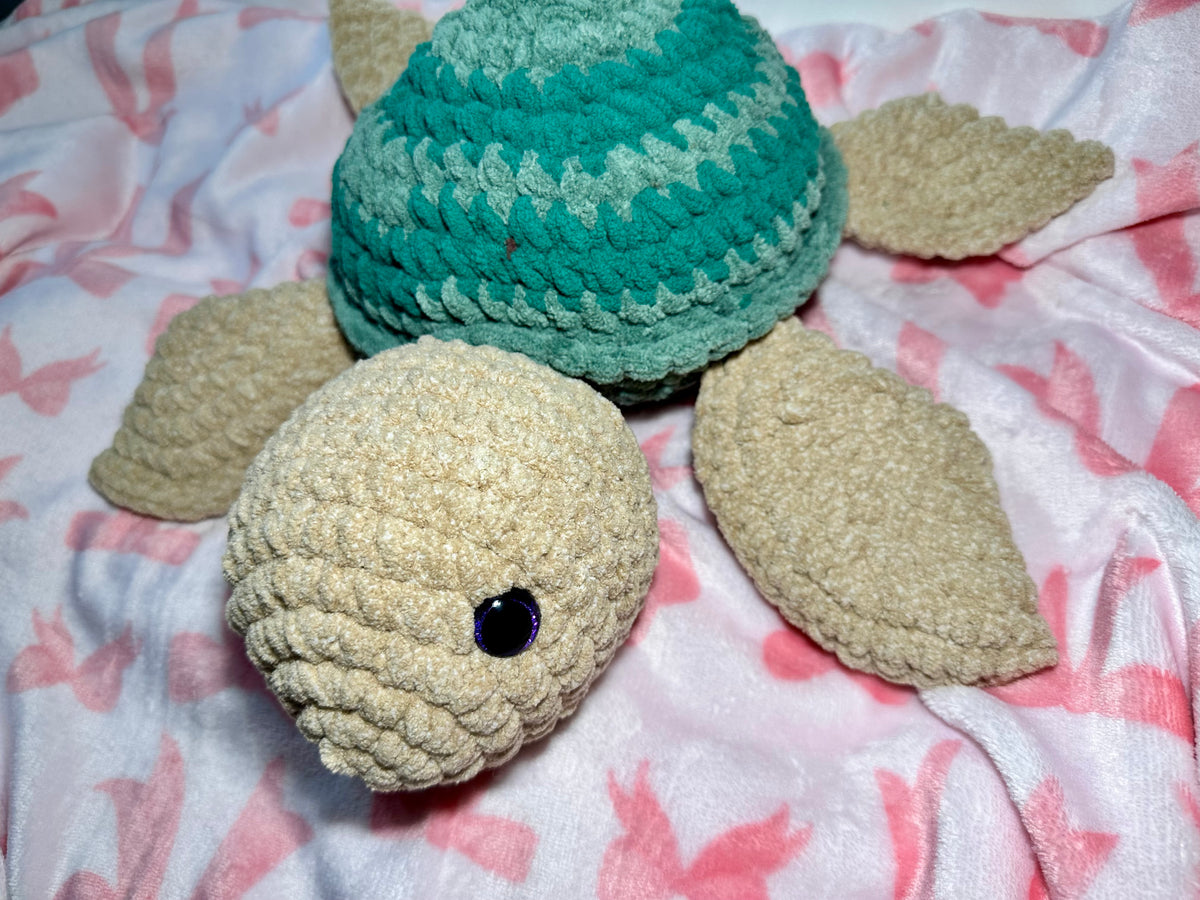 Greeny the Sea Turtle — front view showing deep blue safety eyes and beige head